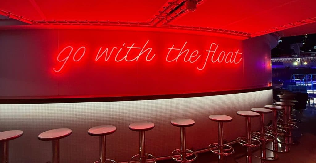 Photo of a sign that says "Go with the float"