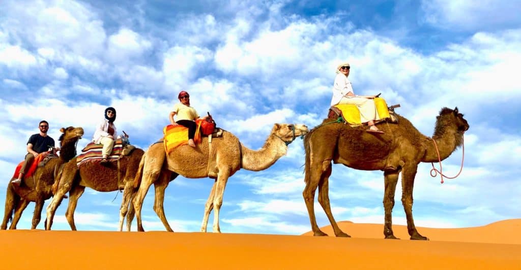 Photo of Eleanor and friends riding camels in Morocco